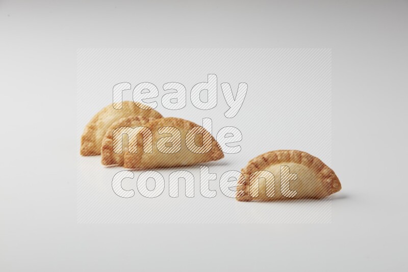 Four fried sambosas on a white background