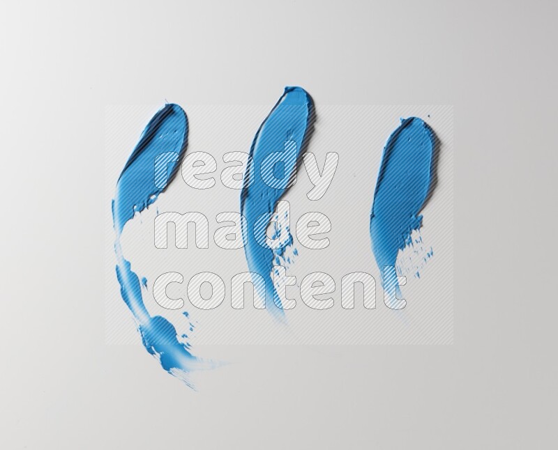 Blue painting knife strokes on white background