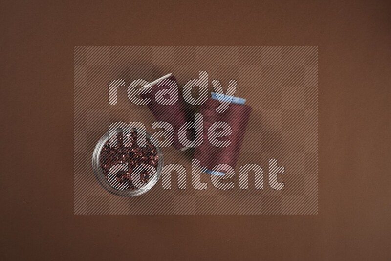 A red collection of sewing and tailoring tools arranged on a brown background