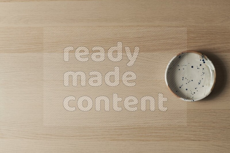 A multicolored pottery bowl on light wooden background