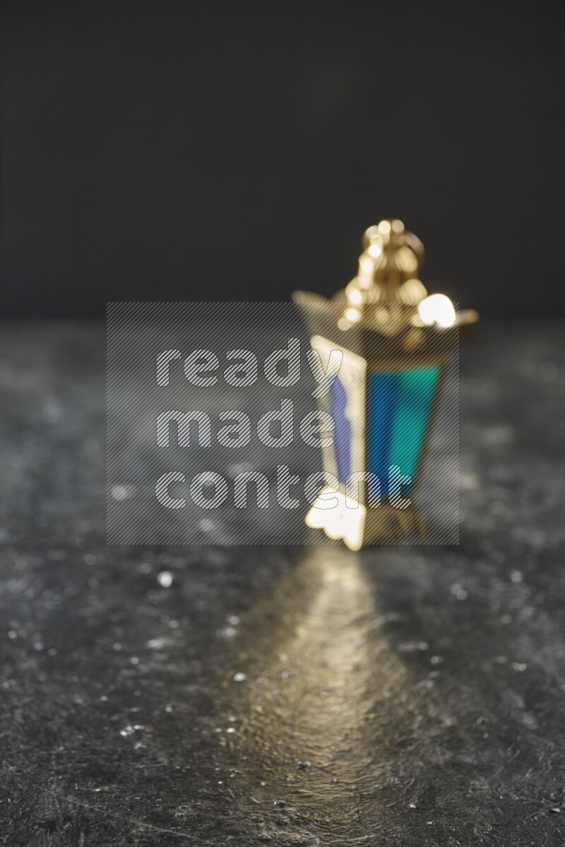 An out of focus lantern on textured black background