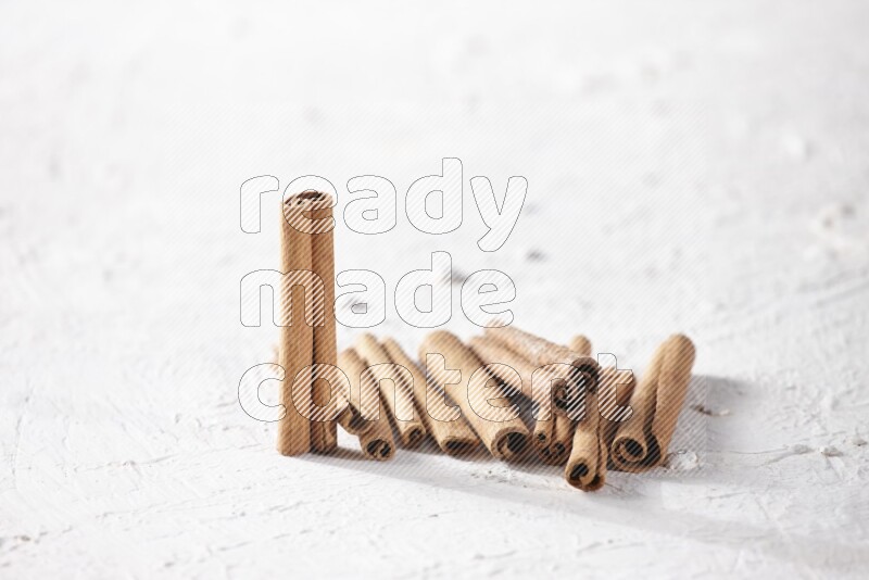 Cinnamon sticks on a textured white background