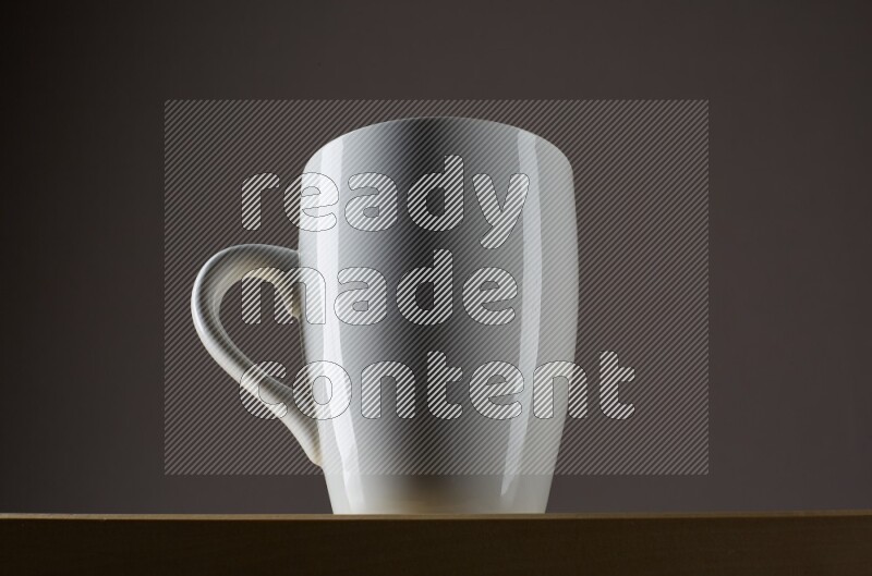 Low angle shot of a white cup on grey background