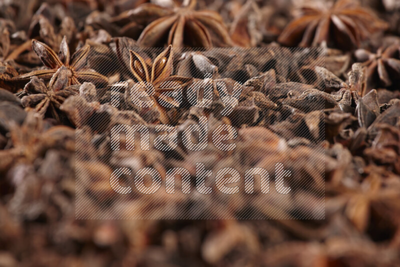 Star Anise fill the frame on black flooring