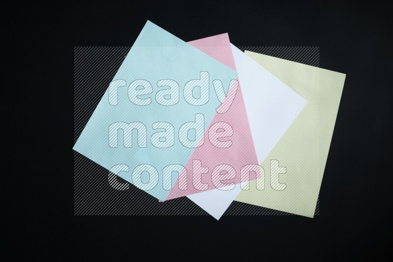 Multicolored paper sheet on black background