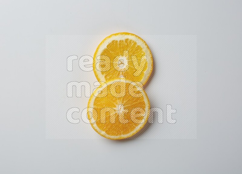 Two orange slices on white background