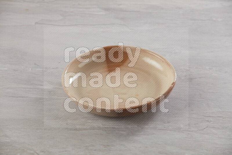 multi color ceramic round plate on grey textured countertop