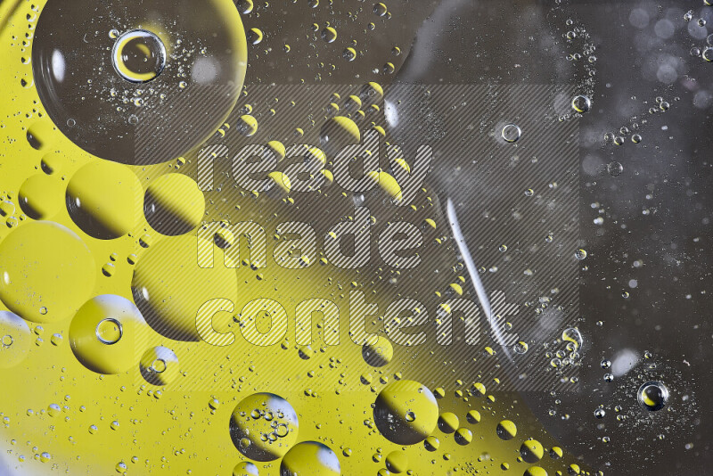 Close-ups of abstract oil bubbles on water surface in shades of yellow and brown