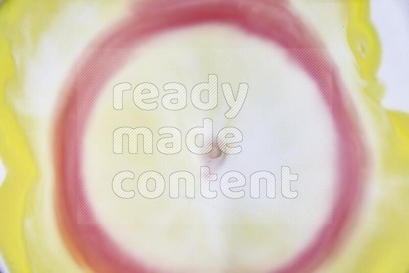 A close-up of abstract swirling patterns in yellow, red and white