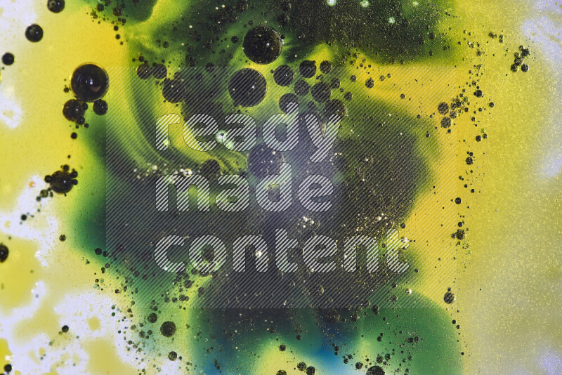 Close-ups of abstract yellow, blue and green watercolor drops on oil Surface on white background