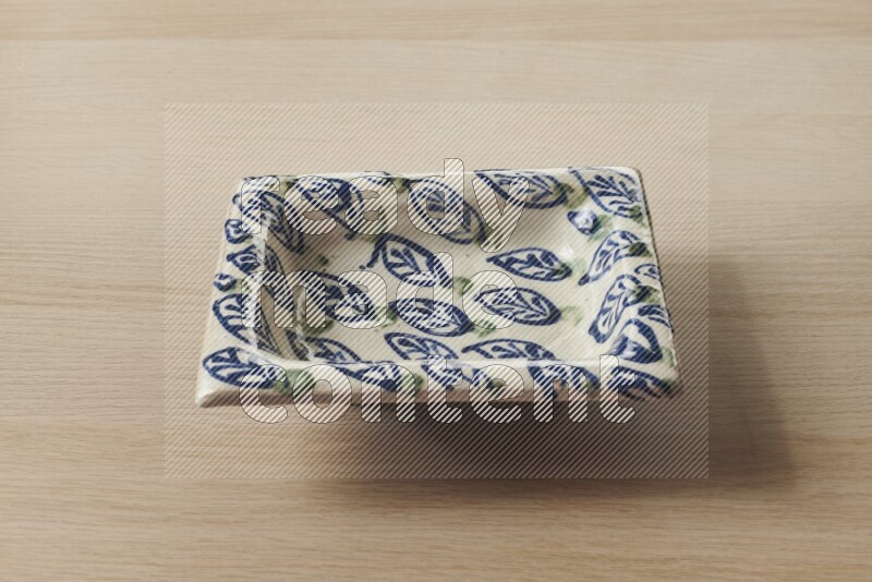 صحن فخاري مزخرف على خلفية خشبية فاتحة