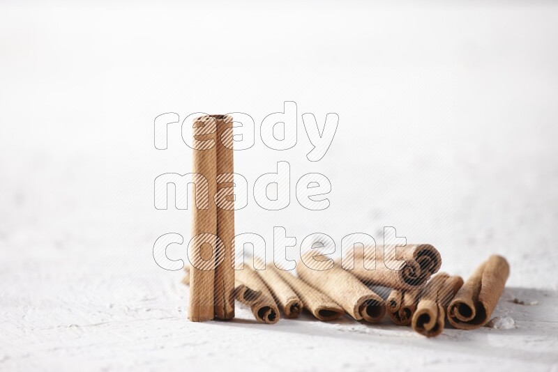 Cinnamon sticks on a textured white background