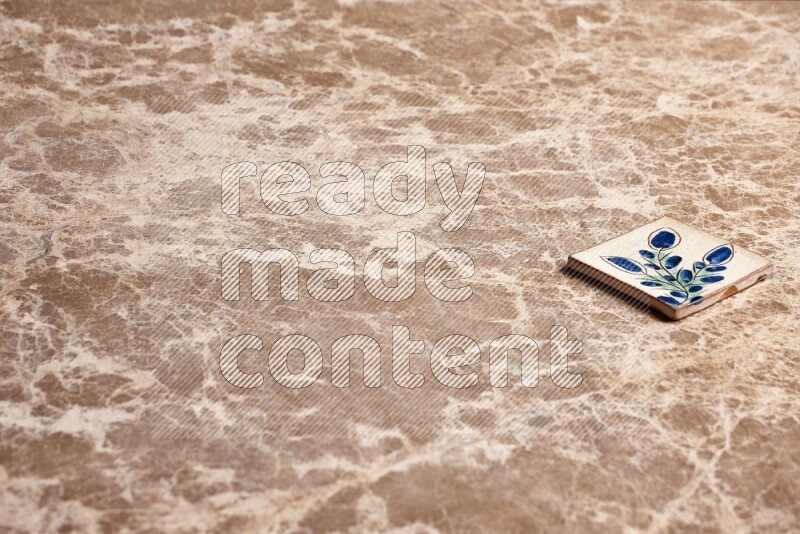 A decorative coaster on beige marble background