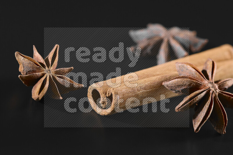 Cinnamon sticks and star anise on black background