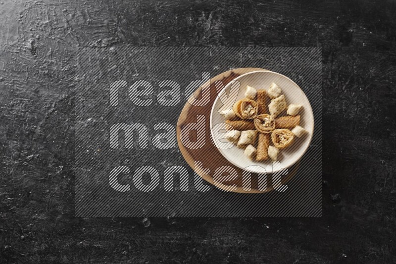 Oriental sweets in pottery plates in a dark setup