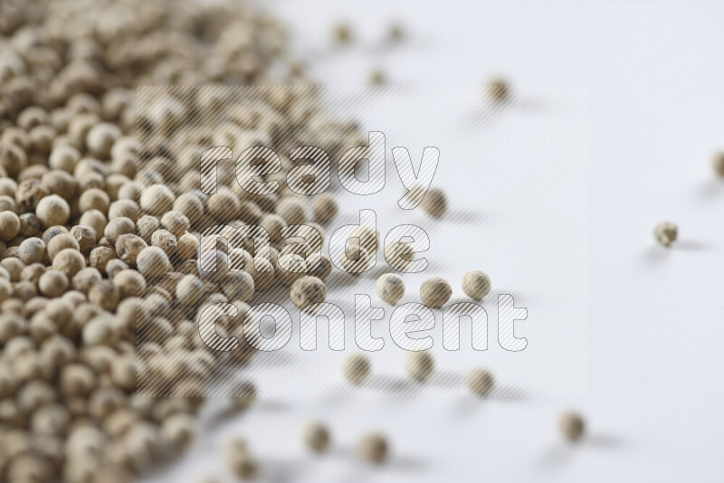 White pepper beads on white background