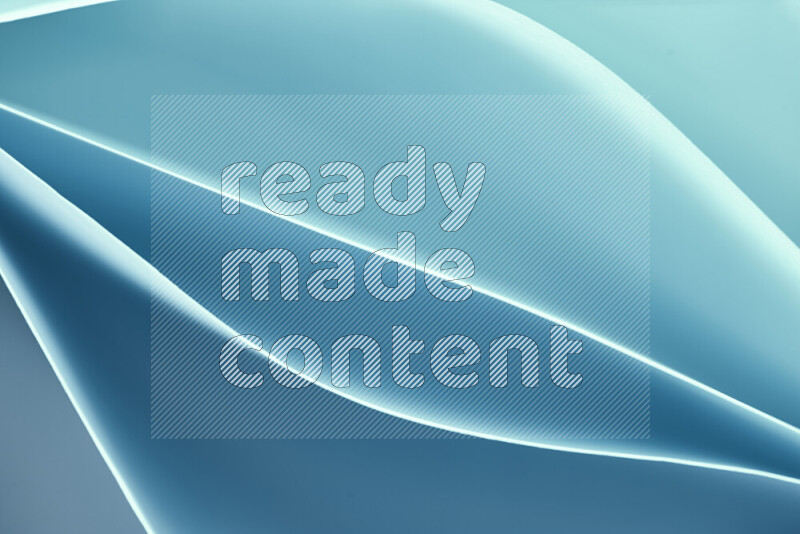 This image showcases an abstract paper art composition with paper curves in blue gradients created by colored light