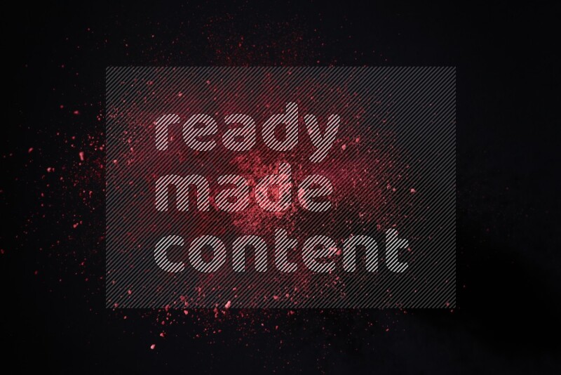 Red powder explosion on black background