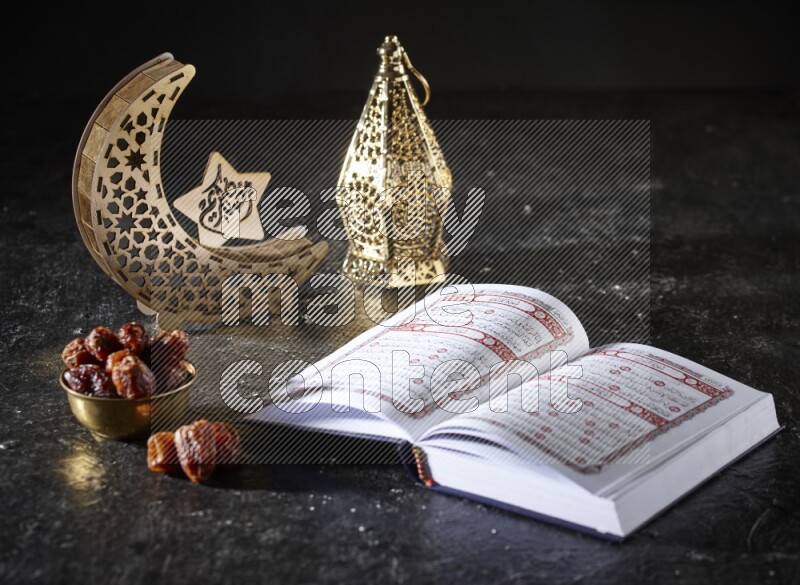 Dates in a metal bowl with quran beside golden lanterns in a dark setup
