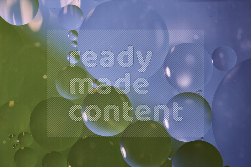 Close-ups of abstract oil bubbles on water surface in shades of blue and green