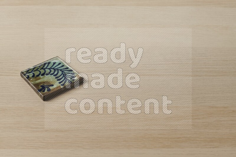 A decorative coaster on light wooden background