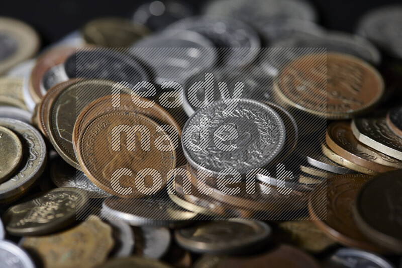 A close-ups of random old coins on black background