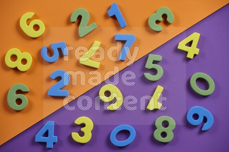 Colorful foam numbers for kids on orange and purple background (kids toys)