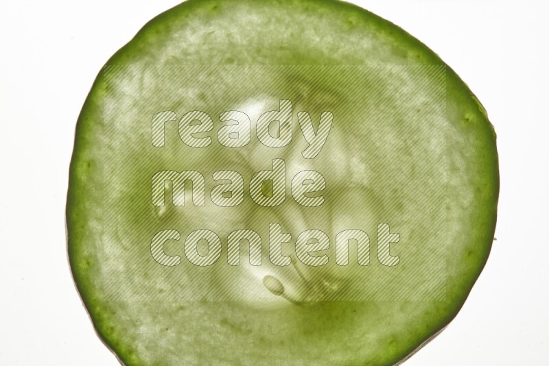 Cucumber slices on illuminated white background