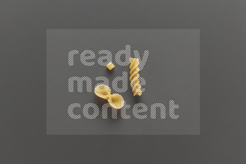 Different pasta types on grey background