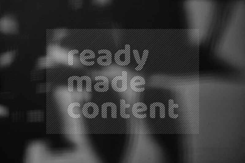 A delicate gobo light projects the silhouette of plant leaves onto a smooth surface