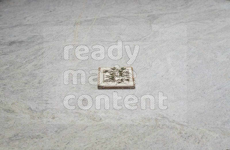Top view shot of a pottery coaster\ tile on beige marble flooring