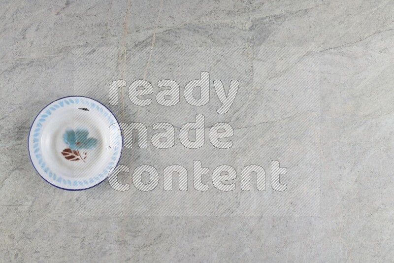 A vintage metal plate on grey marble background