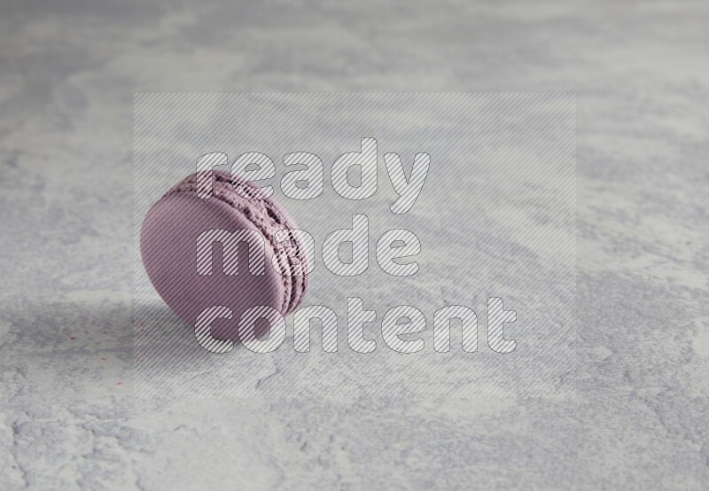 45º Shot of Purple Blueberry macaron on white  marble background