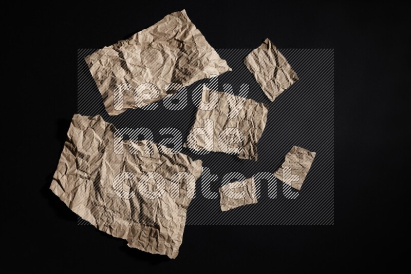 Crumpled craft paper on black background