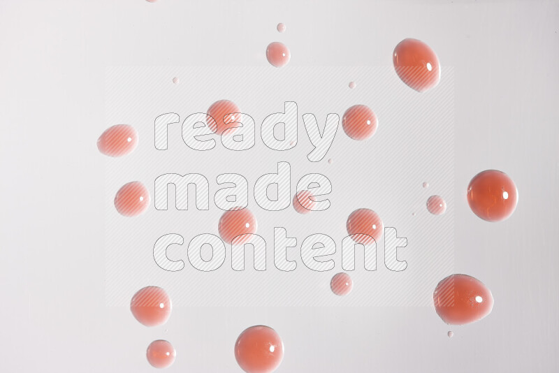 Close-ups of abstract red paint droplets on white background