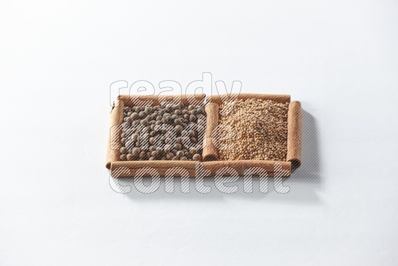 2 squares of cinnamon sticks full of mustard seeds and allspice on white flooring