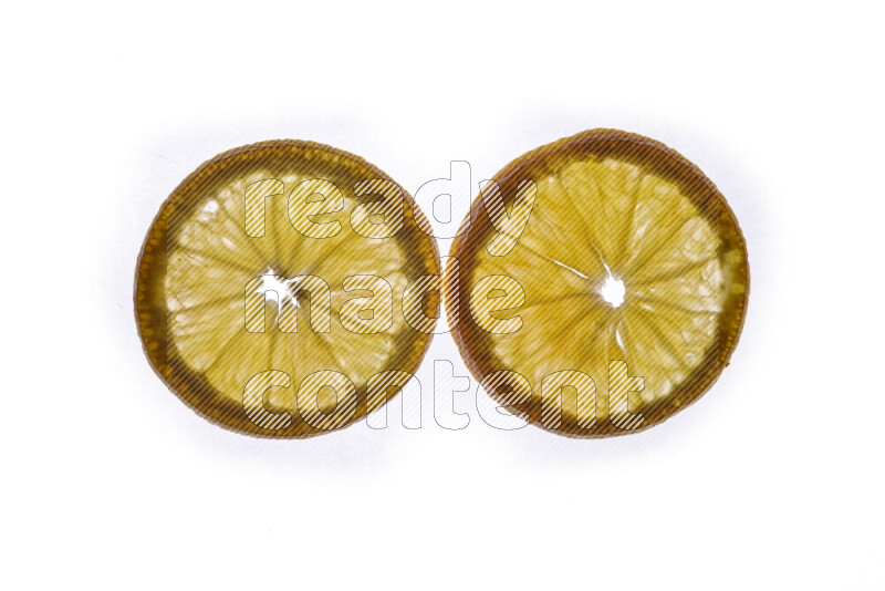 Orange slices on illuminated white background