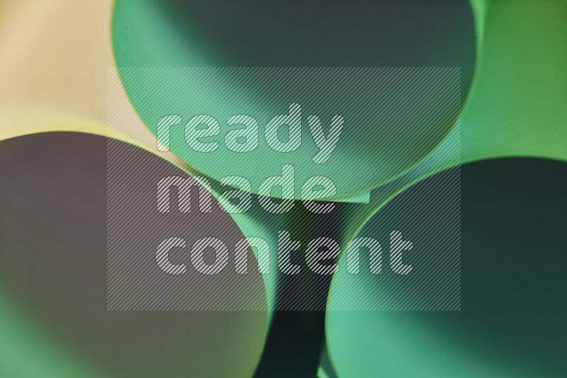 The image shows an abstract paper art with circular shapes in varying shades of green and warm tones