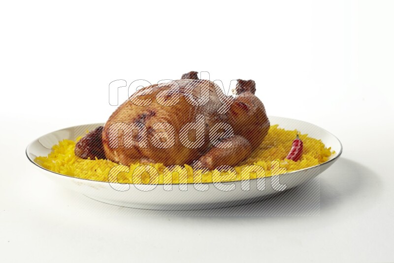 yellow  basmati Rice with kabsa chicken pieces on a white plate with a silver rim direct on white background