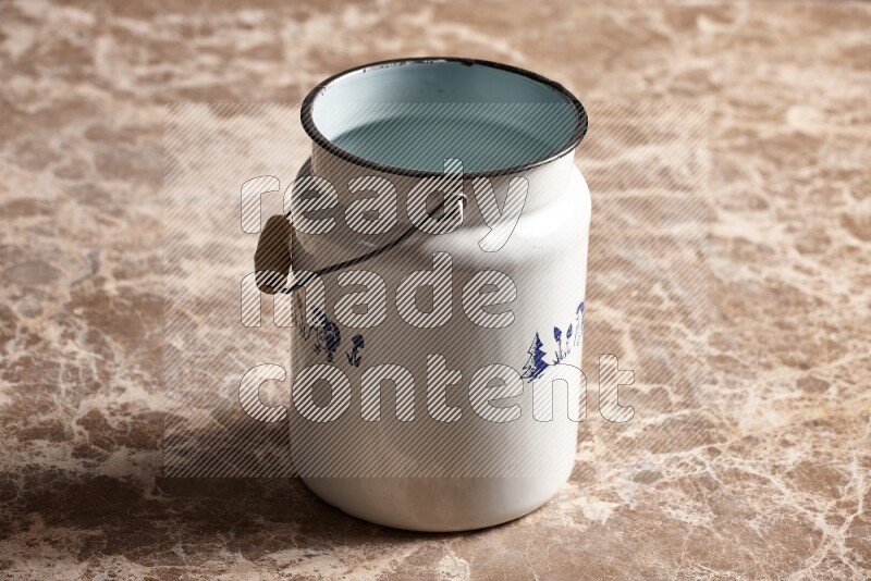 A vintage milk can on beige marble background