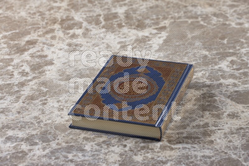 The holy Quran on beige marble background