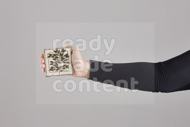 A woman in black abaya holding different pottery essentials in different positions