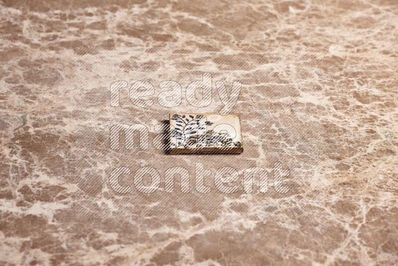 A decorative coaster on beige marble background