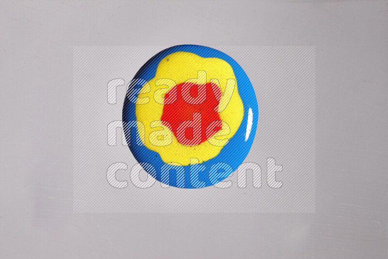 Close-ups of assorted colors blending on a grey background