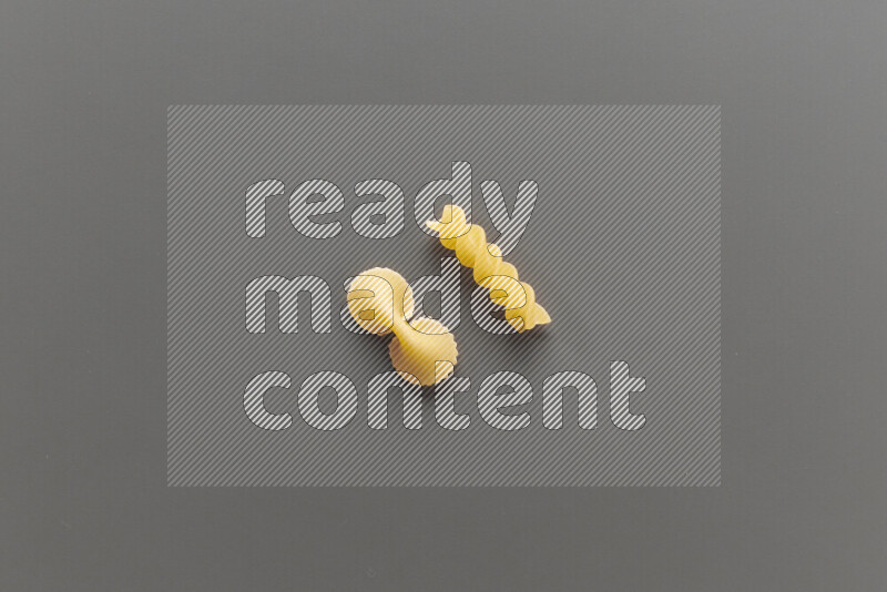 Fiocchi pasta with other types of pasta on grey background