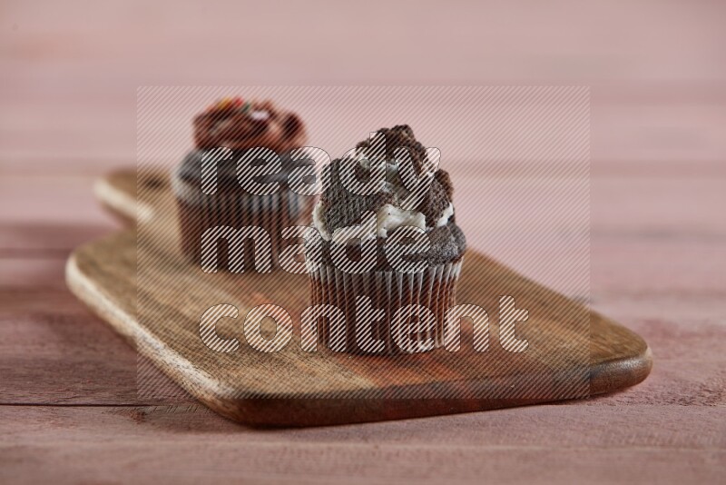 Chocolate mini cupcake topped with oreo on a wooden board