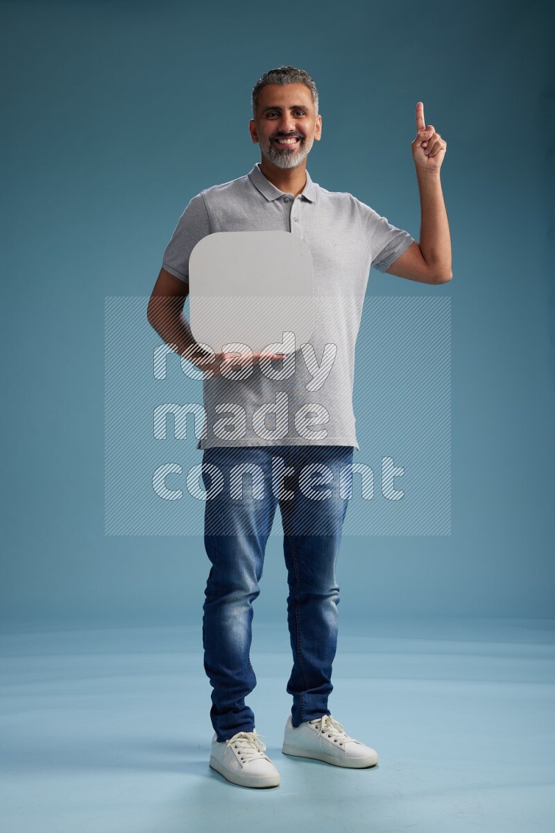 Man Standing holding social media sign on blue background