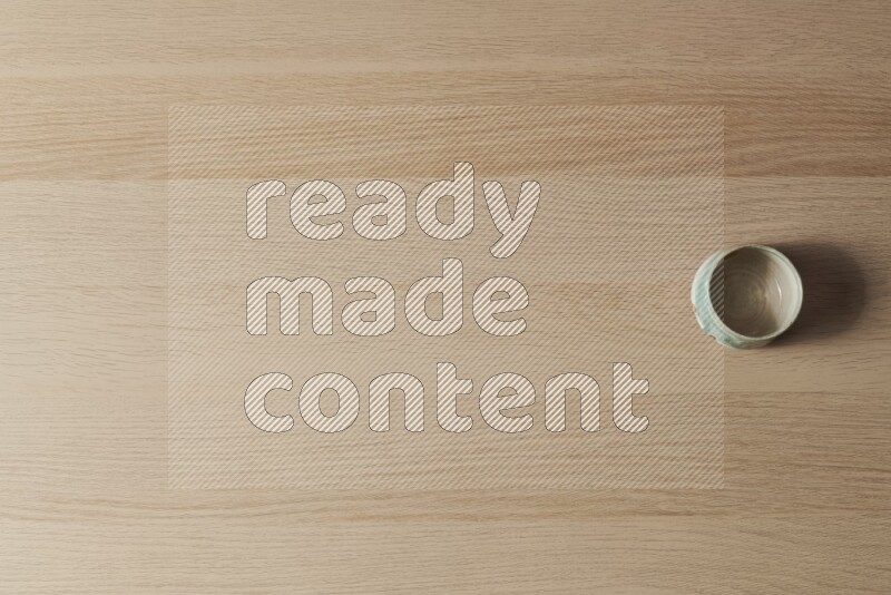 A multicolored pottery bowl on light wooden background