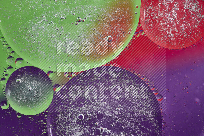 Close-ups of abstract oil bubbles on water surface in shades of purple, green and red