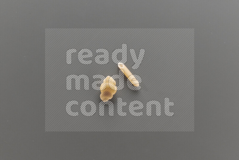 Snails pasta with other types of pasta on grey background